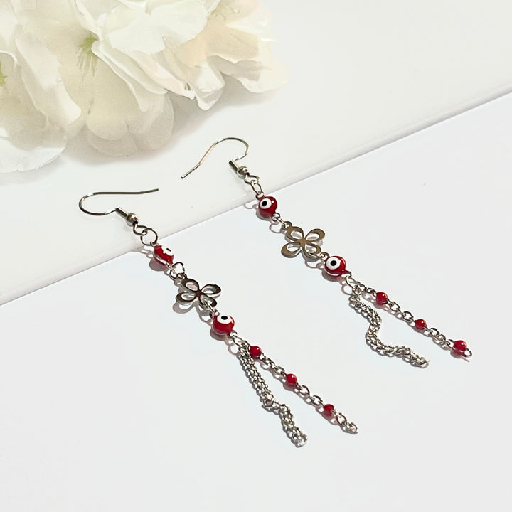 Aretes de Acero Ojo Turco Rojo Flor 🌹| Nicola Joyería 